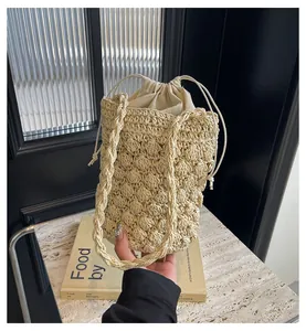 Macro shot of beige woven bucket bag featuring 3D popcorn texture and drawstring liner