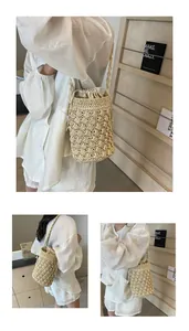 Detail of hand-woven straw bucket bag with drawstring closure and textured weave