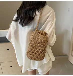 Detail of hand-woven straw bucket bag texture with drawstring lining and woven strap