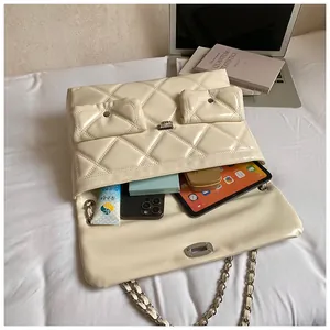 Quilted chain shoulder bag detail showing spacious interior for tablet and daily items