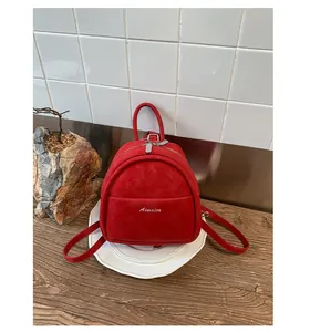 Mini red backpack for women in matte finish with slim straps and Aimaier lettering