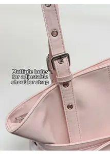 Detail showing the adjustable light pink strap with silver buckle on the tote bag