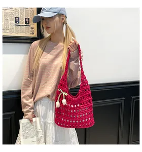 Detailed handmade crochet tote bag in vibrant rose red with white tulip pendant decor