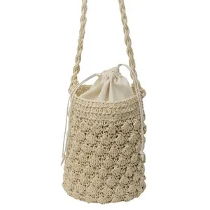 Handmade cream woven bucket bag with popcorn stitch texture and drawstring liner