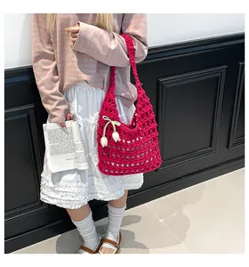 Detail of handmade hollow crochet tote bag with tulip floral charm in rose pink color