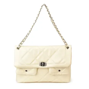 Beige quilted crossbody bag with rhinestone buckle and chain strap on white background