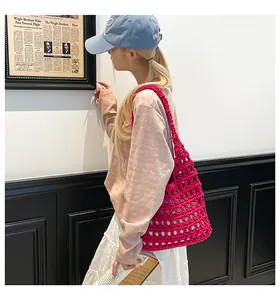 Close-up of vibrant rose red crochet tote bag with hollow woven mesh design for casual style