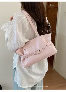 Detailed view of pink glossy faux leather tote bag with metal buckle and stitch craft