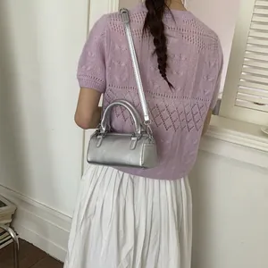 Chic silver cylinder boston bag with dual handles and crossbody strap for daily style