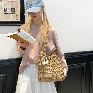Handmade woven hollow tote bag in khaki with floral pendant for summer vacation style