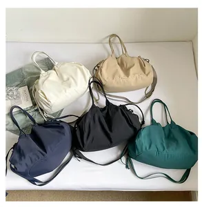 Detailed top view of pleated tote bags in five colors with long adjustable straps