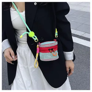 Close-up of a colorful mini mesh crossbody bag with red zipper and neon strap detail