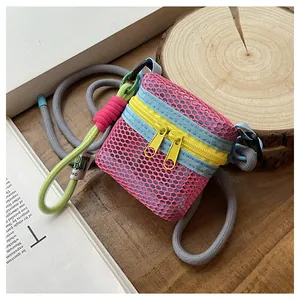 Detail of pink mesh mini crossbody bag with contrast zippers and braided rope strap