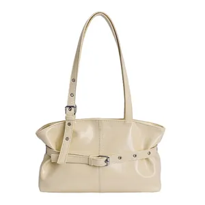 Minimalist cream leather tote bag with decorative buckle strap and spacious interior