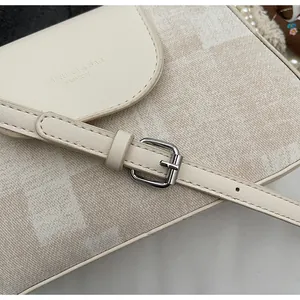 Detail of the vintage square bag showing textured fabric and brand logo on the flap