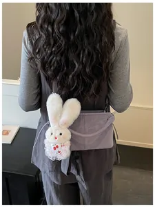 Detail of purple soft leather tote bag with a cute white bunny plush pendant for women