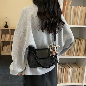 Retro black crossbody bag with jacquard texture, braided handle and pearl pony charm
