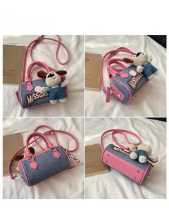 Detail view of the mini Boston bag showing front side back and bottom angles with plush dog