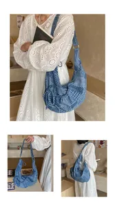Detail of blue patchwork denim hobo bag with adjustable strap and drawstring accents