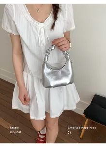 Silver crescent handbag with pleated cloud handle and metallic leather texture details