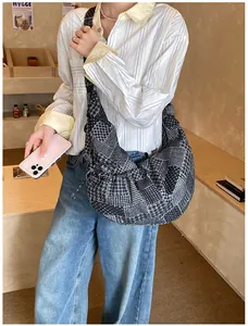 Detail of multi-pattern patchwork dumpling bag with houndstooth and polka dots texture