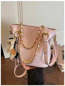 Pink quilted bucket bag detail with gold chain strap and fashion lettering logo