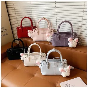 Six colorful PU leather bucket bags on a leather sofa featuring plush bear pendants
