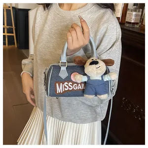 Blue denim Boston bag with Miss Gail embroidery and a cute plush dog charm detail