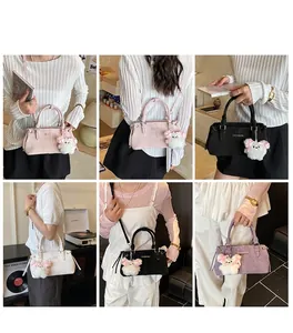 Detail of four colorful bucket bags with cute plush bear charms and adjustable straps