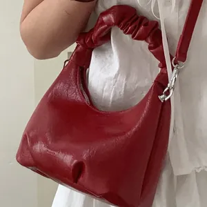 Chic red pleated handbag with scrunchie handle and leather shoulder strap for women