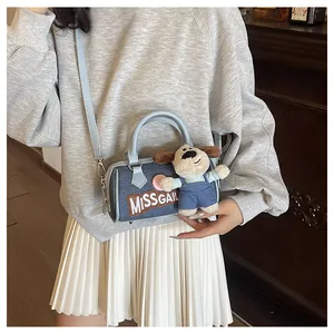 Blue denim Boston bag detail featuring MISSGAIL embroidery and a cute puppy plush charm