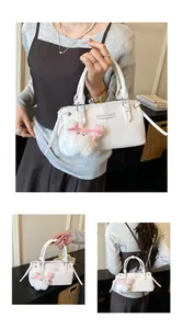 Detailed views of a white leather crossbody bag with fashion plaque and plush charm