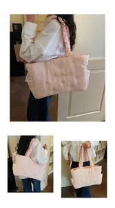 Detail of pink quilted nylon tote with ruffled shoulder strap and side storage pocket