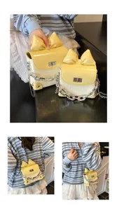 Detail view of mini bow crossbody bag with woven texture and yellow patent flap