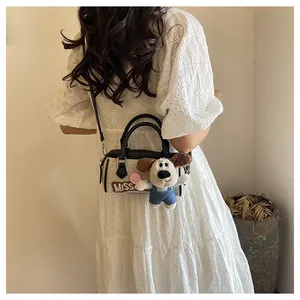 Detail of Boston bag with Miss embroidery and cute plush puppy charm accessory