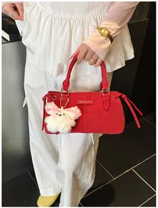 Detail of red bucket bag with Fashion & Bags logo and white plush rabbit charm