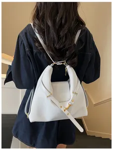 Detail van lichtblauwe tas van oliewasleder met goudkleurige hardware en bandontwerp