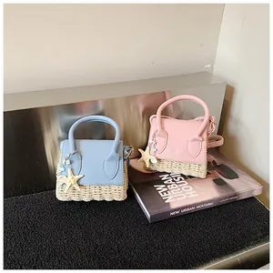 Detail of mini summer handbags with straw weave base and starfish charms in blue and pink