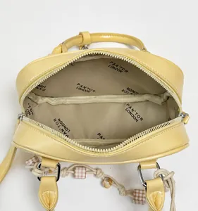 Macro view of bright yellow handbag interior with printed lining and metal zipper