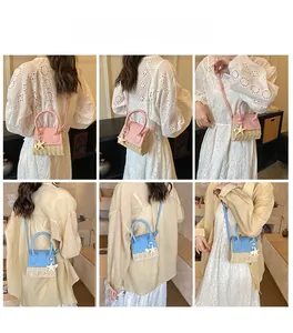 Mini straw handbag with leather detail and starfish charm shown in pink and blue styles