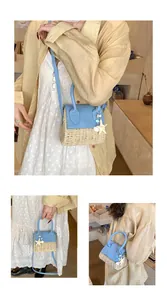 Mini straw shoulder bag with blue leather trim and a starfish charm accessory