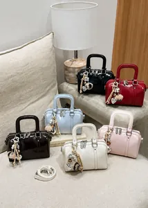 Detailed macro view of vibrant patent leather mini bags in multiple colors with heart charms
