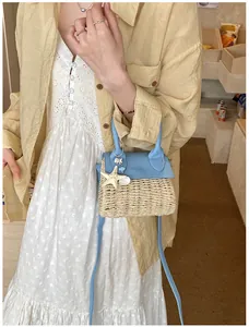 Detail of mini straw bag featuring light blue leather flap and starfish seashell charms