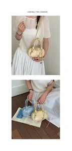 Macro detail of mini Boston pillow bags in yellow and blue with decorative beaded chains