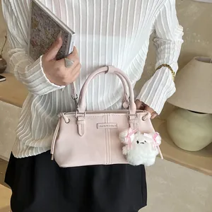 Pink large capacity bucket bag with plush dog charm for spring 2026 fashion trends