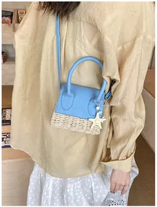 Mini straw woven crossbody bag with blue contrast stitching and a cute starfish charm