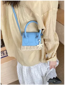Detail of mini summer woven crossbody bag with blue leather flap and starfish charm