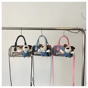 Three colorful Boston bags with MISSGAIL embroidery and plush puppy pendant on metal rack