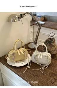Close-up of minimalist mini crossbody bags in yellow and white on a wooden table