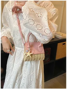 Detailed view of summer straw and leather mini crossbody bag with starfish charm